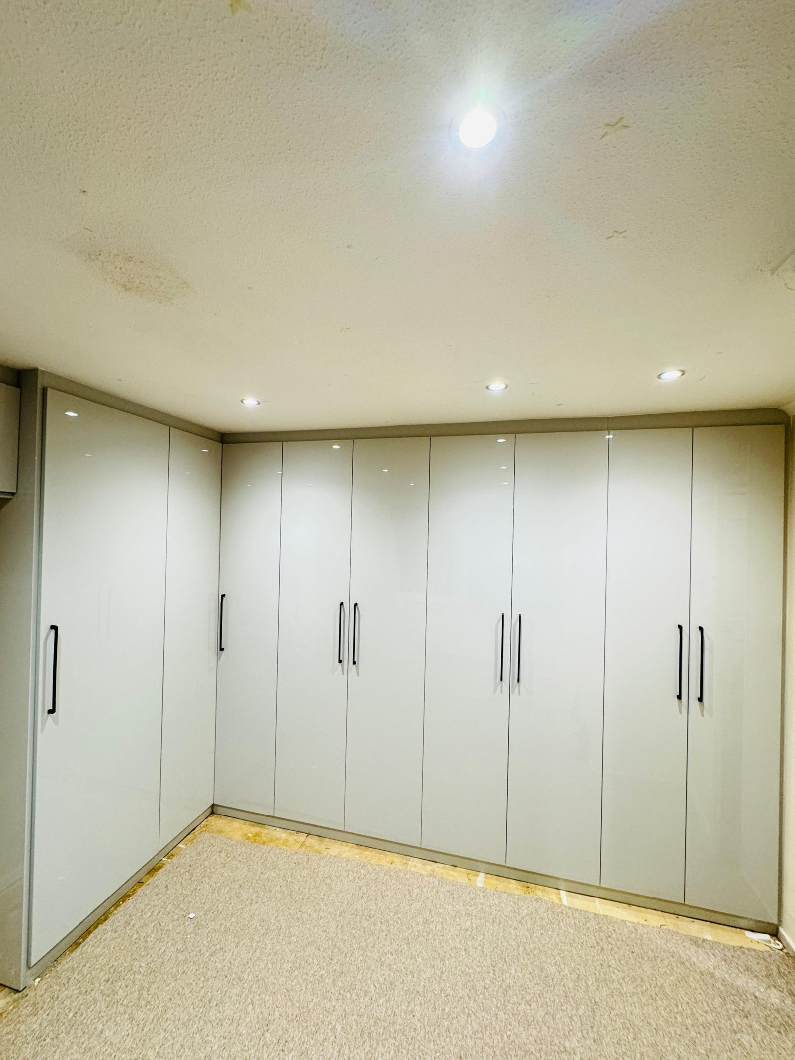 A finished run of fitted wardrobes in a West London bedroom